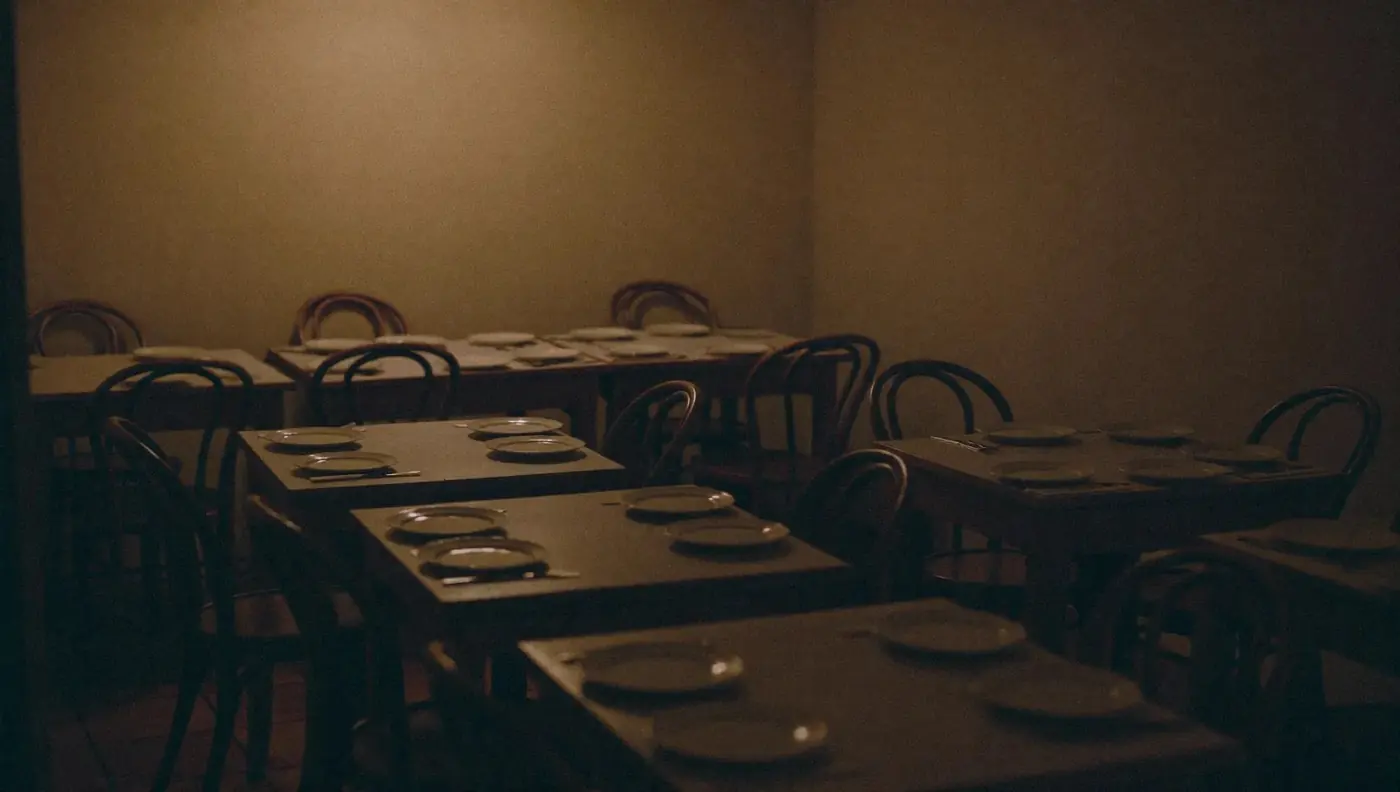 A quiet Italian dining room laid up for the evening